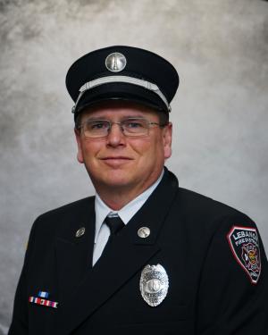 Division Chief of Fire & Life Safety Ken Foster in Class A Uniform and hat